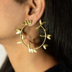 Masaira Laurel gold-plated leaf hoop earring — on-ear three-quarter close-up