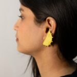 Right-side medium crop: Masaira Eclipse brushed gold-plated half-moon stud on ear