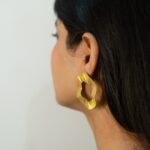 Rear three-quarter view: Masaira Ripple Halo brushed gold-plated open-circle stud on ear