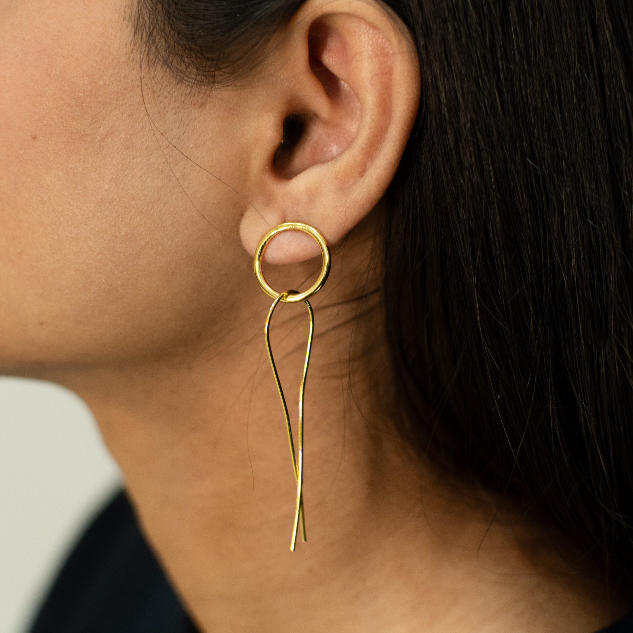 Close-up shot of Masaira’s Slay earrings, minimalist geometric gold-plated design.
