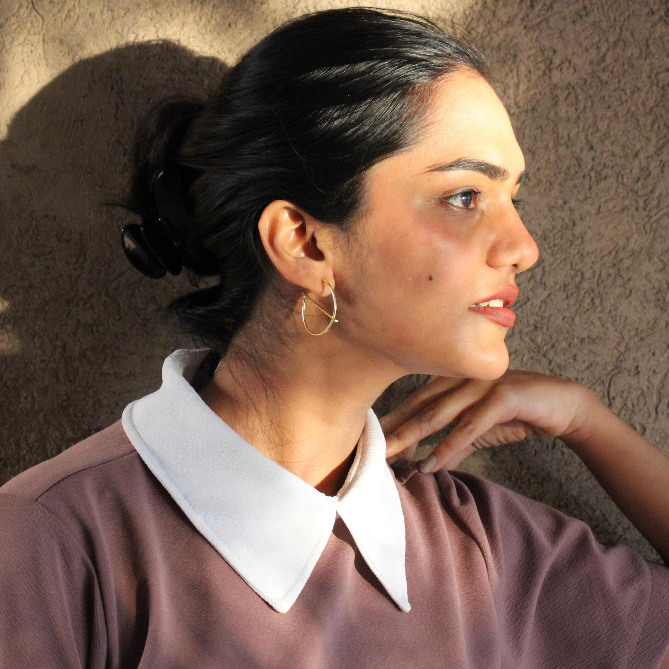 Minimalist gold hoop earrings "Solace" styled on model, geometric circle bar design, modern statement jewelry by Masaira.