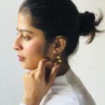 "Minimalist gold-plated hoop earring with dual sphere accents styled on model – modern contemporary jewelry by Masaira"