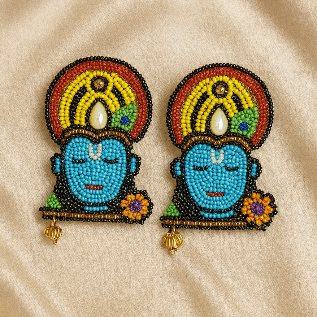 Handcrafted beaded Krishna face earrings with vibrant colors on a satin beige background — Masaira deity-inspired jewellery