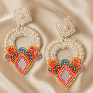 Handcrafted Shimmering Arch festive earrings with pearl, mirror, and colorful bead embroidery on satin background.