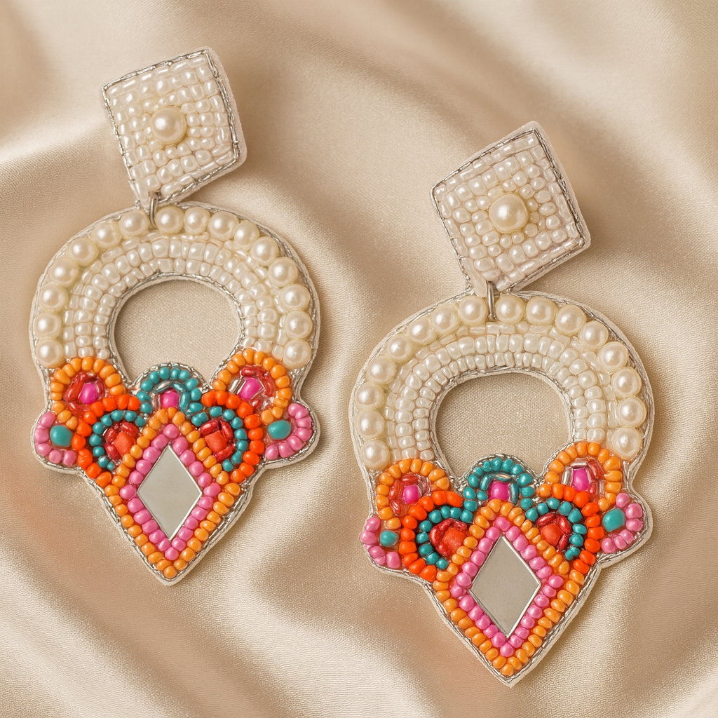 Handcrafted Shimmering Arch festive earrings with pearl, mirror, and colorful bead embroidery on satin background.