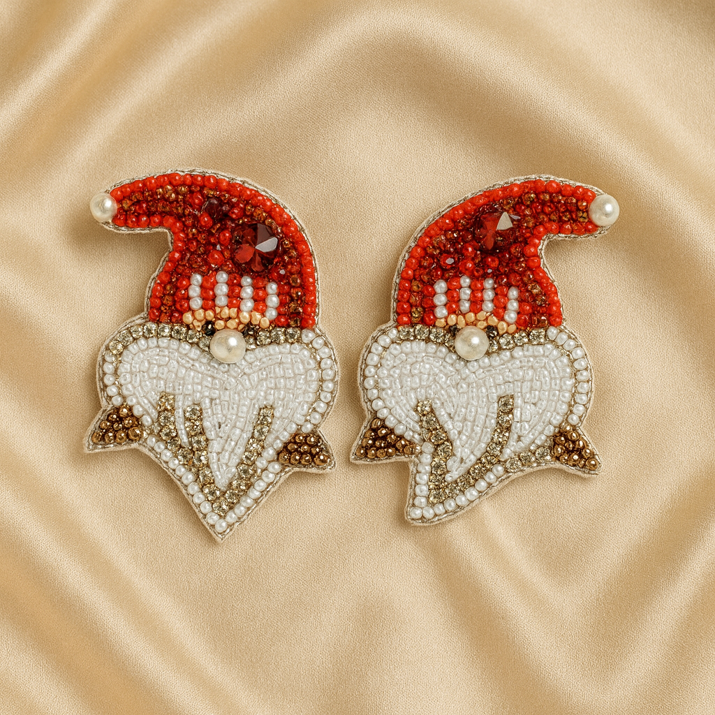 Pair of handcrafted Santa hat earrings on golden satin fabric