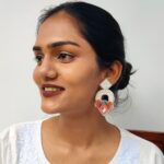 Smiling woman in white kurta wearing colorful handcrafted Shimmering Arch earrings
