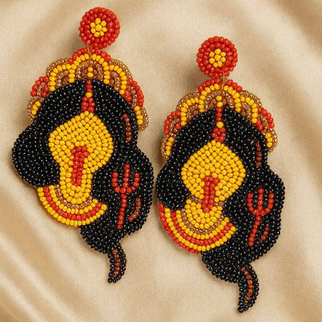 Handcrafted beaded Kali earrings inspired by Hindu Goddess Kali with trident detailing on champagne satin background