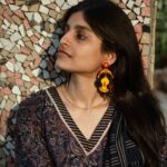 Indian woman wearing beaded Kali earrings inspired by the fierce Hindu Goddess Kali, styled with ethnic attire.