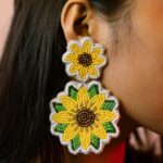 Macro close-up of two-tiered sunflower beaded earrings showing detailed seed bead work.