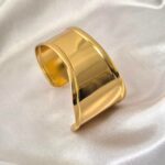 Aurora Curve Cuff Bracelet in 18 Carat Gold Finish on Satin Fabric