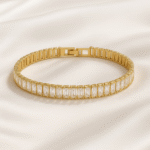 Gold-plated baguette stone bracelet on satin background