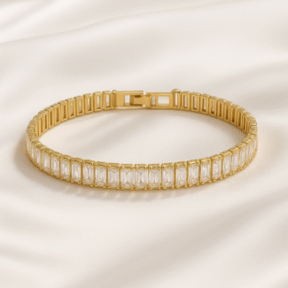 Gold-plated baguette stone bracelet on satin background