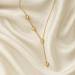 18 carat gold plated necklace with cascading heart motifs on a satin background