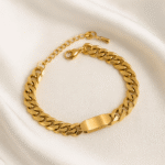 18 carat gold plated unisex curb link bracelet with ID plate on satin background