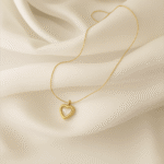 18 carat gold plated open heart necklace on ivory satin background
