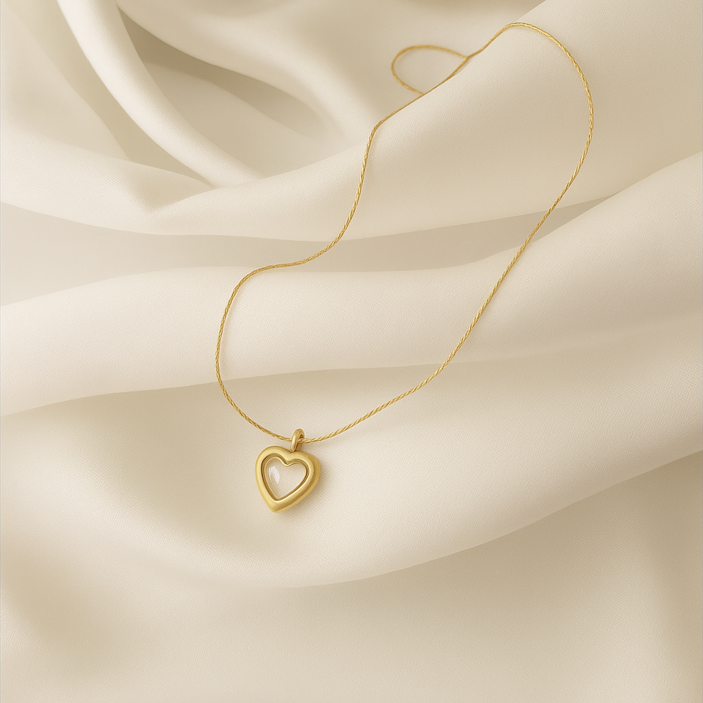 18 carat gold plated open heart necklace on ivory satin background