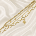 Five-layer celestial gold plated bracelet stack with moons, stars, pearls and crystals on satin background