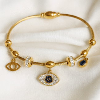 Gold-plated evil eye charm bracelet with cubic zirconia stones and navy enamel from Masaira
