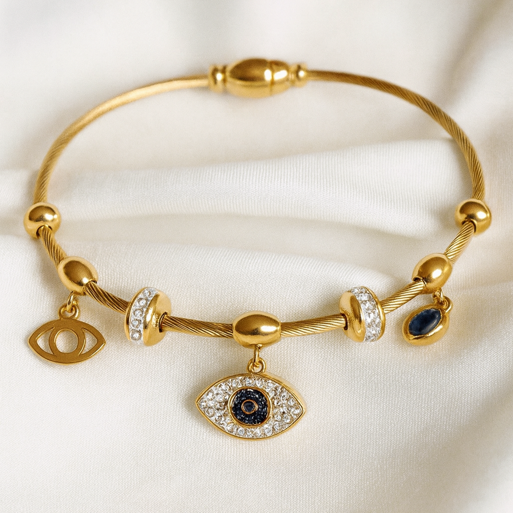 Evil Eye Charm Bracelet – 18K Gold-Plated Cable Bracelet by Masaira Gold-plated evil eye charm bracelet with cubic zirconia stones and navy enamel from Masaira