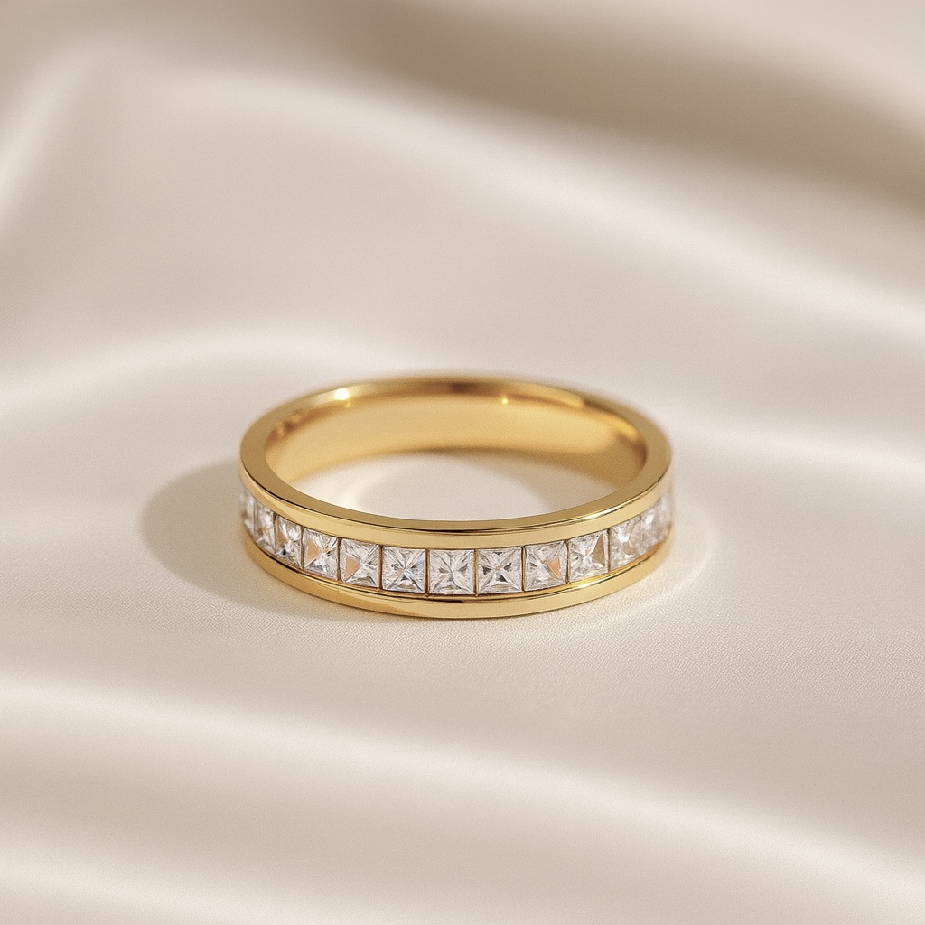 Gold band ring with a row of square-cut clear stones set in the center