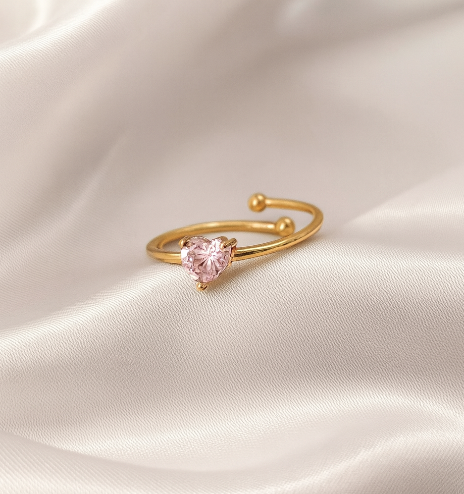 Rosé Whispers 18 Carat Gold Pink Heart Ring – Masaira Gold open ring with a pink heart-shaped stone placed on ivory satin fabric