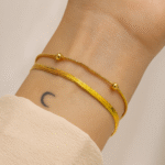 Gold-plated double-layer bracelet with snake and beaded chains on wrist by Masaira