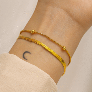 Gold-plated double-layer bracelet with snake and beaded chains on wrist by Masaira