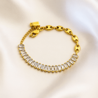 Gold link bracelet with baguette-cut zircon stones on satin background