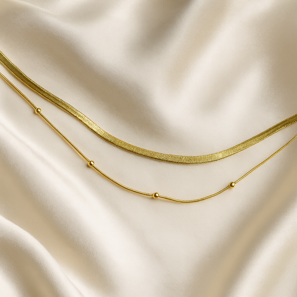 Aurora Duo Necklace | 18 Carat Gold Plated | Hypoallergenic 18 carat gold plated dual-layer necklace with snake chain and beaded chain on satin background
