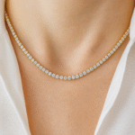 Model wearing 18 carat gold-plated tennis necklace with simulated diamonds