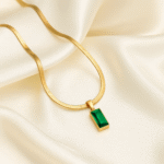 18 carat gold plated herringbone necklace with rectangular emerald green stone pendant