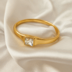 Elegant gold bangle with square-cut stone at center, made with 18 carat gold plating