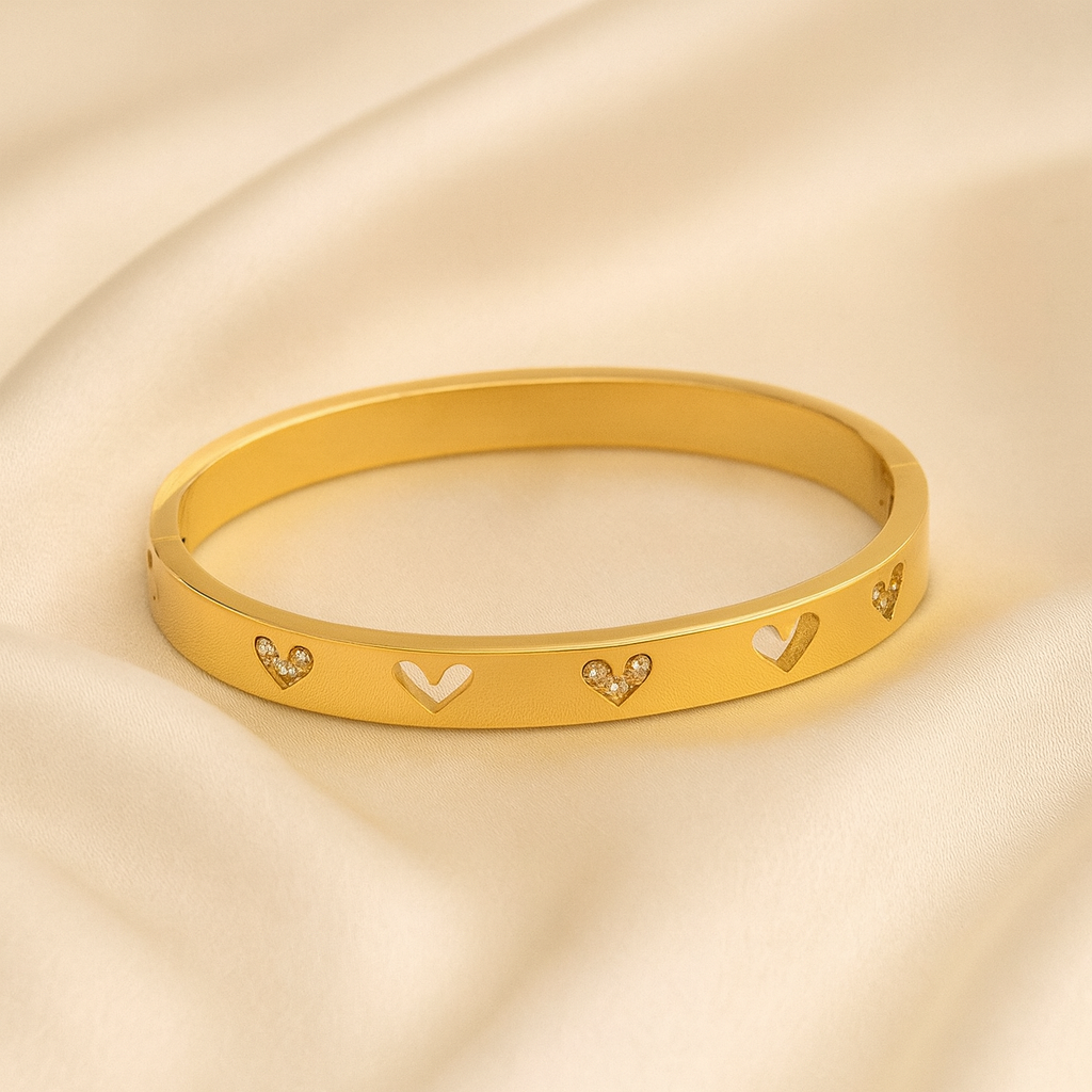 18 carat gold plated kids bangle with cut-out and crystal heart motifs
