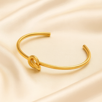 18 carat gold plated open cuff bracelet with central knot design