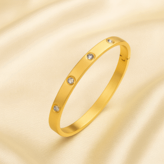 18 carat gold plated bangle with embedded cubic zirconia stones and hinged closure