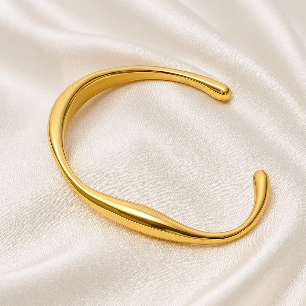 Fluid Arc 18 Carat Gold Sculptural Cuff Bangle – Anti-Tarnish, Hypoallergenic Open sculptural gold bangle with curved edges on satin background