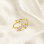 18 carat gold open ring with five marquise-cut cubic zirconia stones on satin background