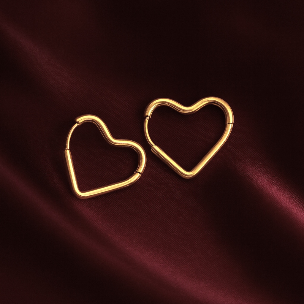 Heartbeat hoops gold platted Masaira earrings Masaira Heartbeat gold-plated heart-shaped hoop earrings on deep maroon satin