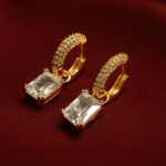 Luxury gold-plated hoop earrings with emerald-cut crystal drops and pavé stones – statement jewelry for evening wear.