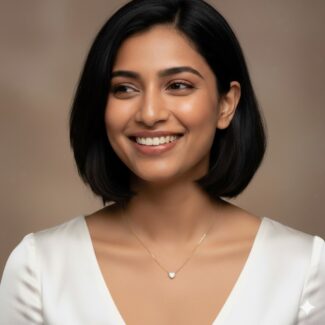 Model wearing the Eternal Heart Necklace, an 18 carat gold plated chain with a heart-shaped cubic zirconia pendant, anti-tarnish and hypoallergenic