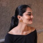 Model wearing gold-plated circular stud earrings with elegant simplicity