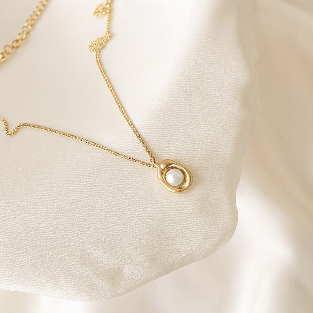 Ethereal Pearl Necklace | 18 Carat Gold Plated | Hypoallergenic 18 carat gold plated necklace with pearl pendant on satin background