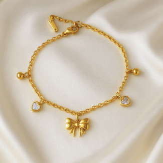 Celeste Charm Bow Bracelet in 18 carat gold with heart and bow accents