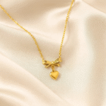 Golden Bowheart Necklace in 18 carat gold with delicate bow and heart pendant