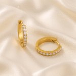 Eternal Gleam Hoops in 18 carat gold with cubic zirconia stones on satin background