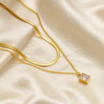 Luminous Duo Necklace in 18 carat gold with layered chains and rectangular stone pendant.
