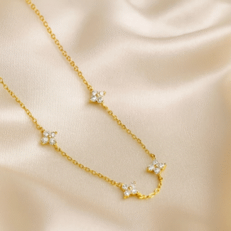Celestial Bloom Station Necklace in 18 carat gold plating with CZ floral motifs.