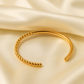 Twist Aura Open Cuff in 18 carat gold plated stainless steel with twisted detailing.