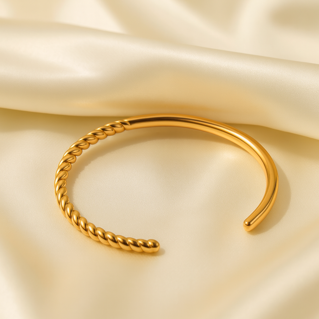 Twist Aura Open Cuff in 18 carat gold plated stainless steel with twisted detailing.